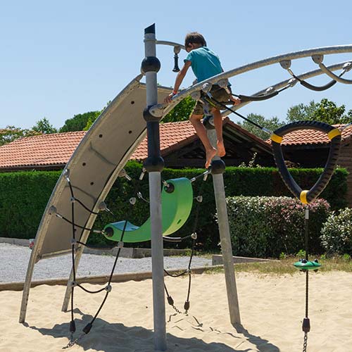 Enfant sur un tobbogans de laire de jeux du camping à Messanges